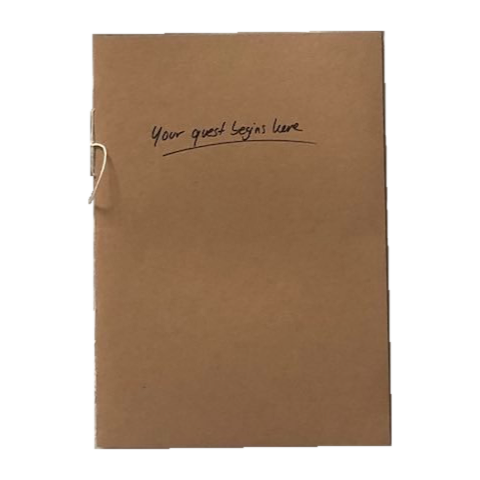 a brown booklet with "your quest begins here" written on the cover